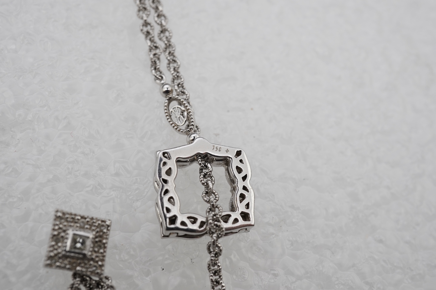 A diamond lariat necklace